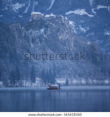 Boats bringing people to Bled island on a cold winter morning