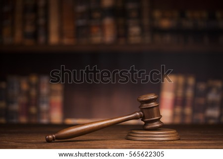 Law theme, mallet of the judge, wooden desk, books