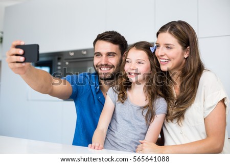 Happy family clicking selfie at home