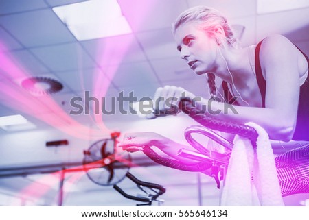 Fit woman on exercise bike at gym