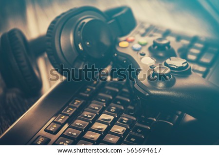 fun gamepad video console gaming game play gamer player headset earphones keyboard concept - stock image
