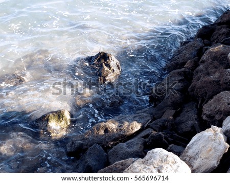 Rocks in the sea water on the coast of the bay
