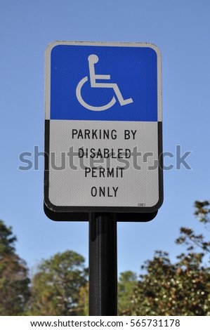 Parking by disabled permit only sign