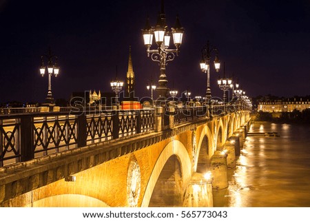 Pont de pierre, old stony bridge in Bordeaux in a beautiful summer night, France