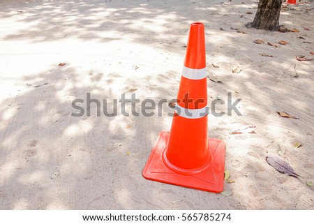 Orange traffic cone on the sand