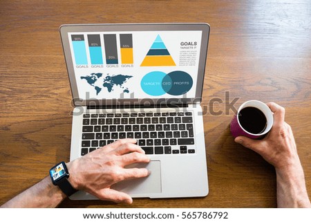 Graphic image of business presentation with charts and map against man using laptop and holding coffee cup