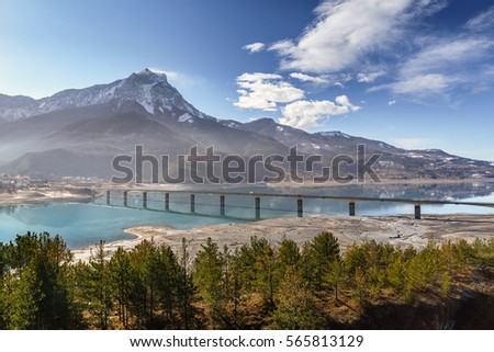 Pont de Savines with Serre-Poncon lake and the Grand Morgon on an early winter morning. Savines-le-Lac, Hautes-Alpes, Southern French Alps. France