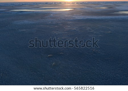 Ice Cold Bay winter natural landscape at sunset