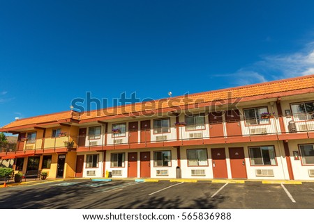 American road motel with blue sky on background. Royalty-Free Stock Photo #565836988