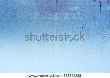 Natural water drops on glass, window with condensation, strong, high humidity Royalty-Free Stock Photo #565842268