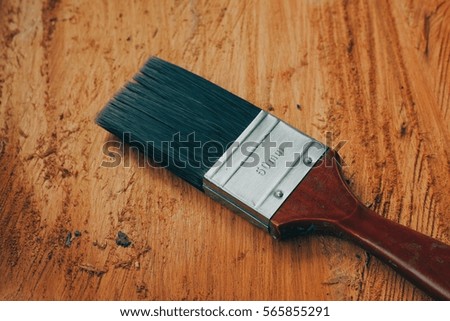 A paint brush over the wood