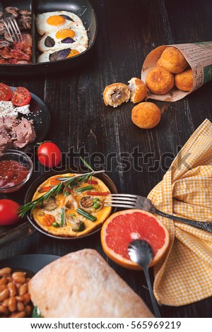 Breakfast on a black wooden table in rustic style