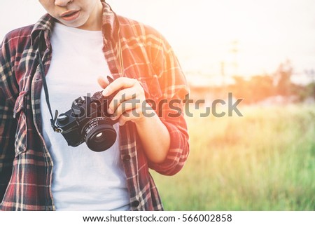 Happy young hipster woman  holds retro photo camera