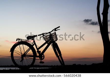 Beautiful landscape image with Bicycle at sunset in vintage tone style