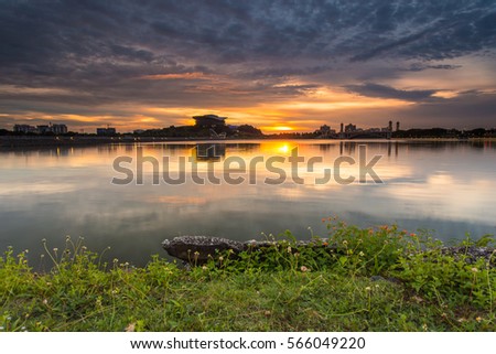 Landmark or building beside Putrajaya dam or lake in sunrise or sunset moment with burning sky