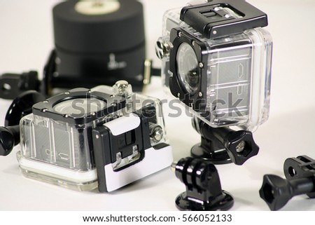 Action camera in a set of mounting hardware inventory, are on the table
