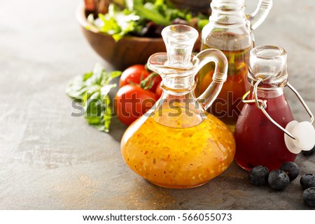 Assortment of vinaigrette salad dressings in glass bottles. Royalty-Free Stock Photo #566055073