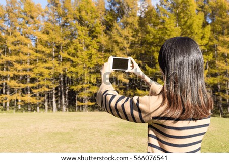 Woman using cellphone to take photo