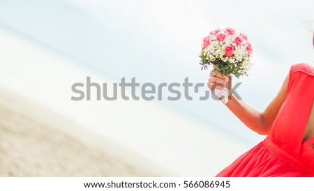 woman holding a bridal bouquet. bridesmaid took wedding flowers