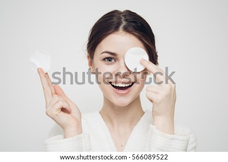 woman with a sponge blue background cotton pad problem skin Royalty-Free Stock Photo #566089522
