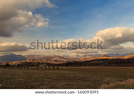 many clouds over the mountains of Italy in a winter day