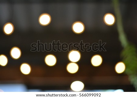 Round orange lights with brown and grey roof and green plant as a background,abstract background,light background.