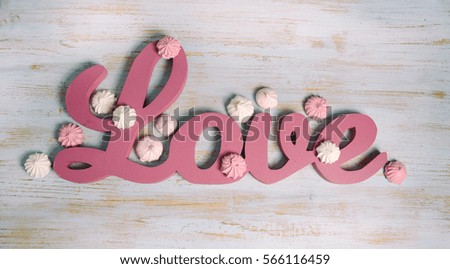  love concept on shabby chic painted wood. valentines day or wedding background with wooden love word, heart shape and copy space.