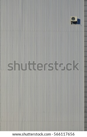 Siding wall panels. Industrial building wall made of corrugated metal sheet with air conditioning, flat background photo texture. Seamless surface of galvanize steel