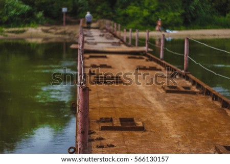rusted iron pontoon across the river