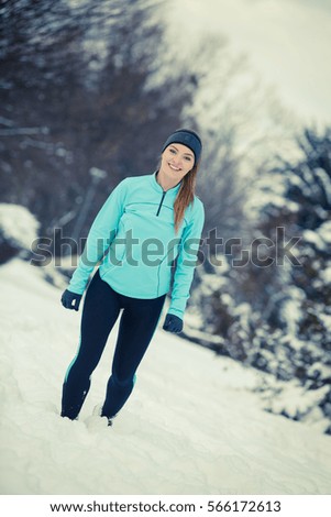 Girl wearing sportswear, trees in background. Winter sports, outdoor fitness, workout, health concept.