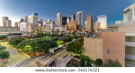Aerial view downtown Houston illuminated at blue hour with green city park and modern skylines light. The most populous city in Texas, fourth-most in US. Architecture and travel background. Panorama.