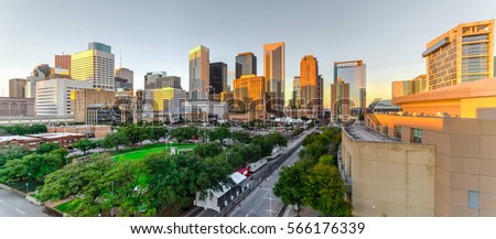 Aerial view downtown Houston illuminated at sunset with green city park and modern skylines light. The most populous city in Texas, fourth-most in US. Architecture and travel background. Panorama.