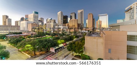 Aerial view downtown Houston illuminated at twilight with green city park and modern skylines light. The most populous city in Texas, fourth-most in US. Architecture and travel background. Panorama.
