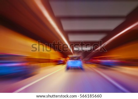 cars quickly go in lit tunnel