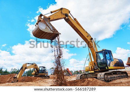 excavator at sandpit during earthmoving works Royalty-Free Stock Photo #566187289