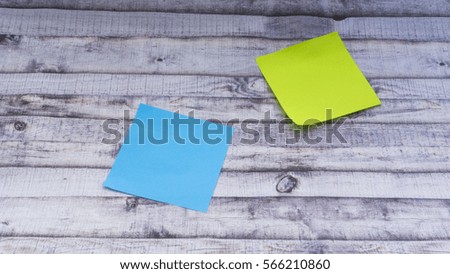 Closeup of Colorful sticky post note with copy space on wooden background. Selective focus.