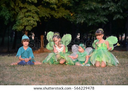 Boy dressed as Peter Pan, two girls and baby in fairy costume. Fairies
