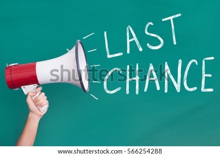 Close-Up Of Person Hand Holding Megaphone with Last Chance Announcement On Blackboard Royalty-Free Stock Photo #566254288