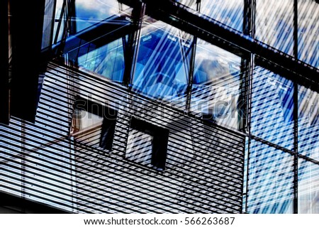 Building exterior with two different types of walls: profiled / corrugated metal and structural glazing. Reworked photo of abstract modern industrial / office architecture fragment Royalty-Free Stock Photo #566263687