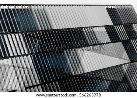 Reworked photo of office building exterior with ajar blinds / jalousie / louvers on windows. Abstract background with louvered structure. Modern architecture, technology or industry motif