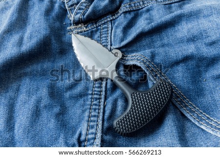 Knife on jeanse background.. Close up. Army knife.