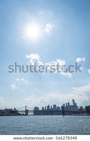 A view of the Manhattan skyline from the East River on a bright sunny day
