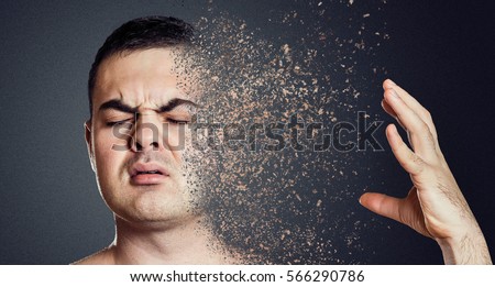 Depressive man dissolving his face into pieces. Mental health concept.