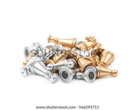 Pile of golden and silver chess figures isolated over the white background
