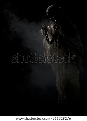Ghostly figure floating in grave yard on black background halloween themed image