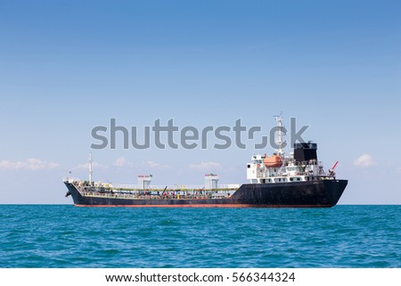 Oil cargo ship in ocean skyline with clear blue sky background