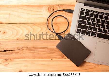 external Hard with Laptop on wooden background