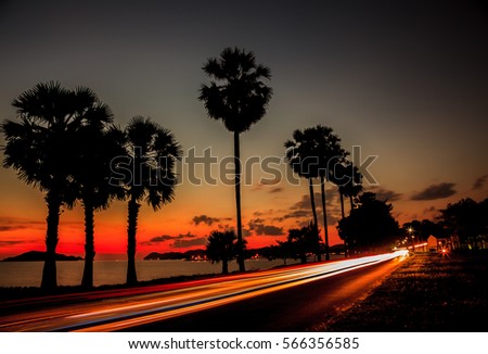 Motion blur light car on beach twilight silhouette low speed shutter Chon buri Thailand
