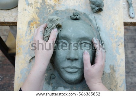wet clay mask lies on the table of the sculptor Royalty-Free Stock Photo #566365852