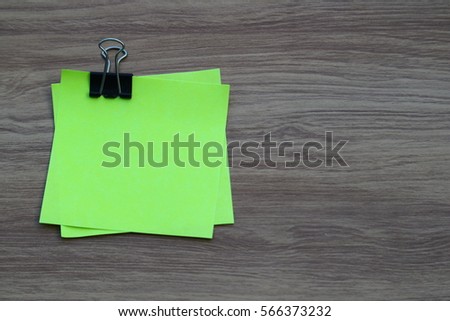 Reminder note paper with clip on wooden background, education business concept with copy space for text
